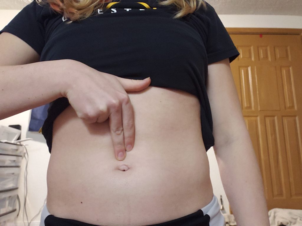 use three fingers and press down right above your belly button