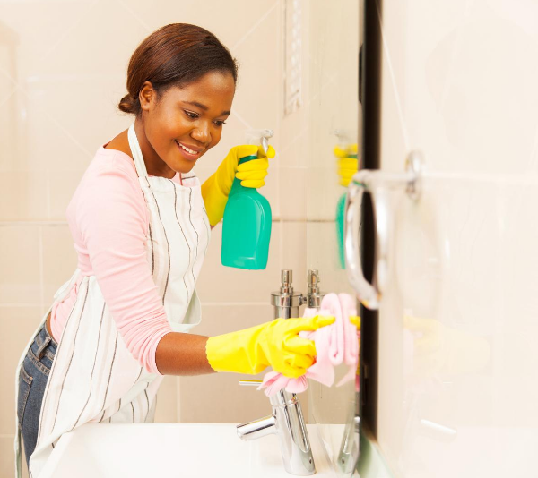woman cleaning bathroom