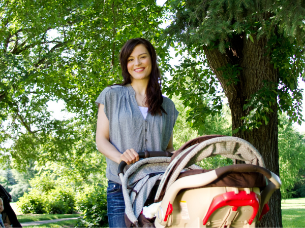 woman walking baby in the stroller after a c-section