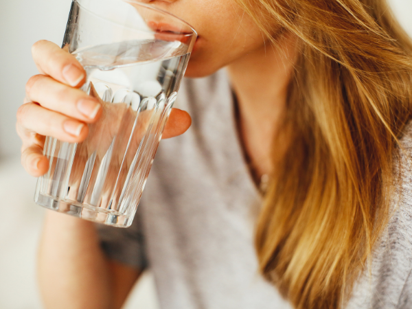 woman drinking lots of water after a c-section